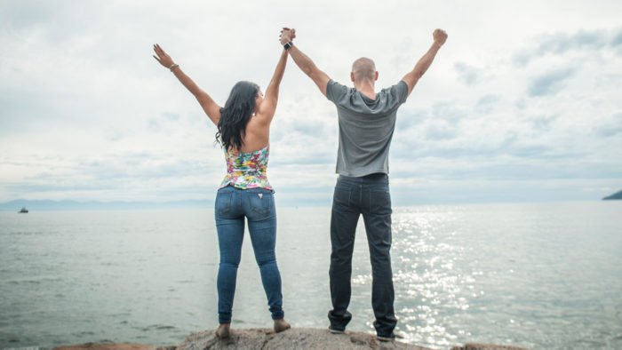 Two people holding hands raised in the air